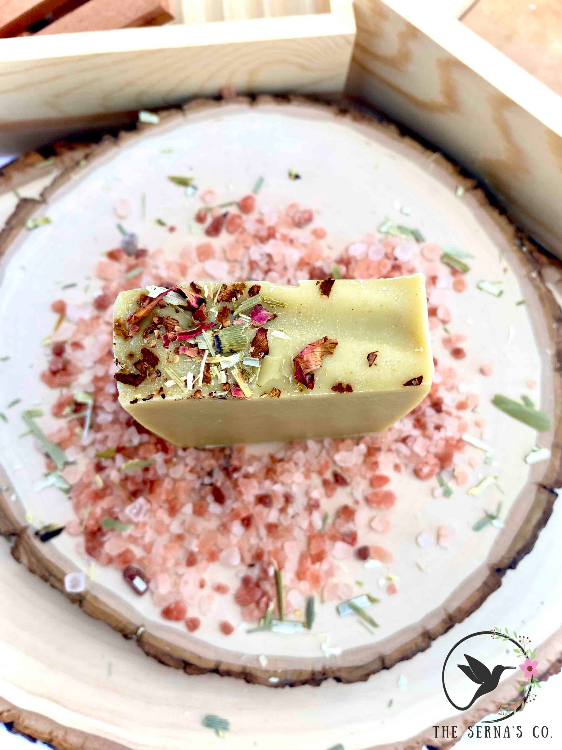 Soap bars displayed on wood with ingredients 