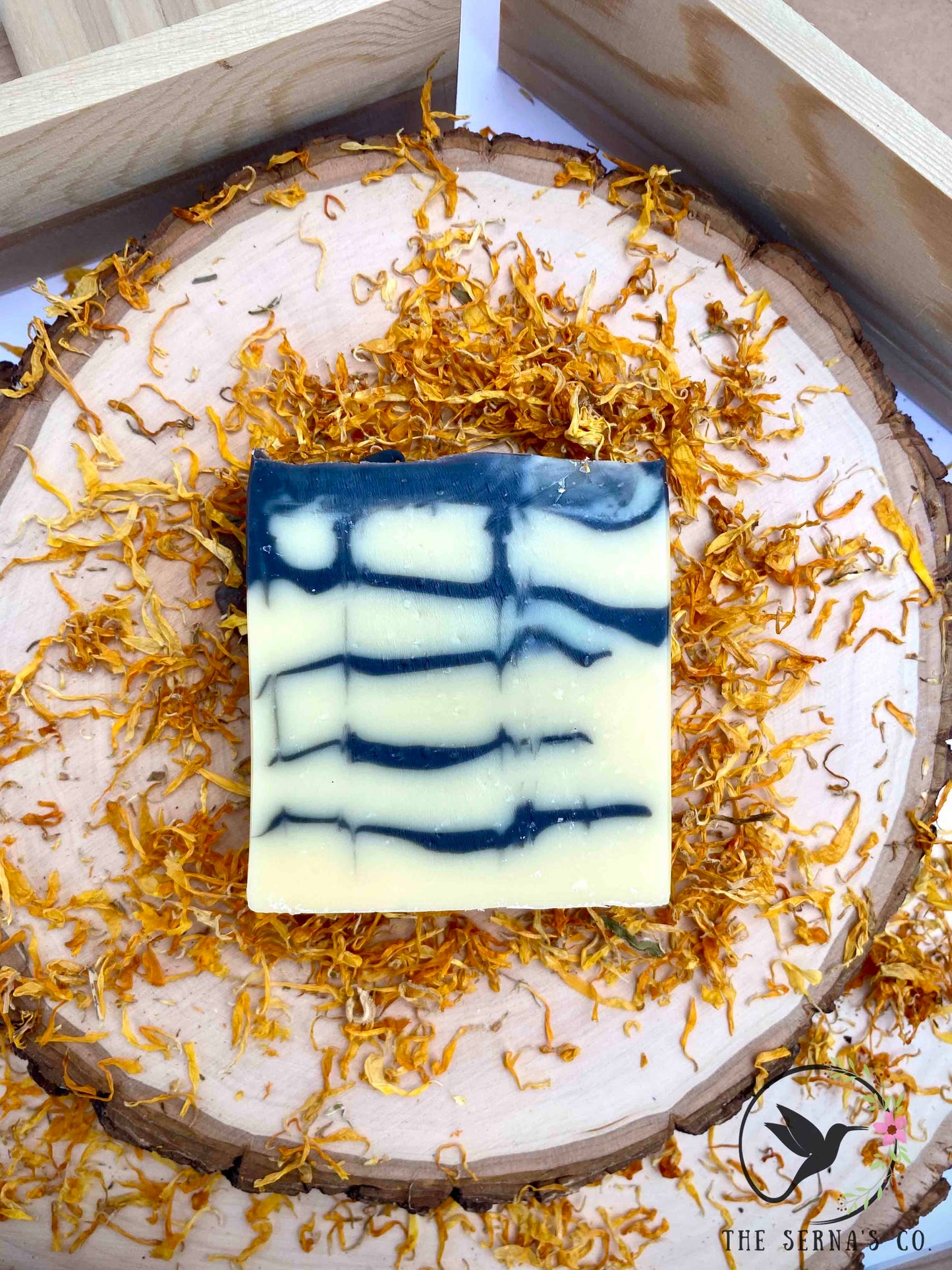 Soap bars displayed on wood with ingredients 