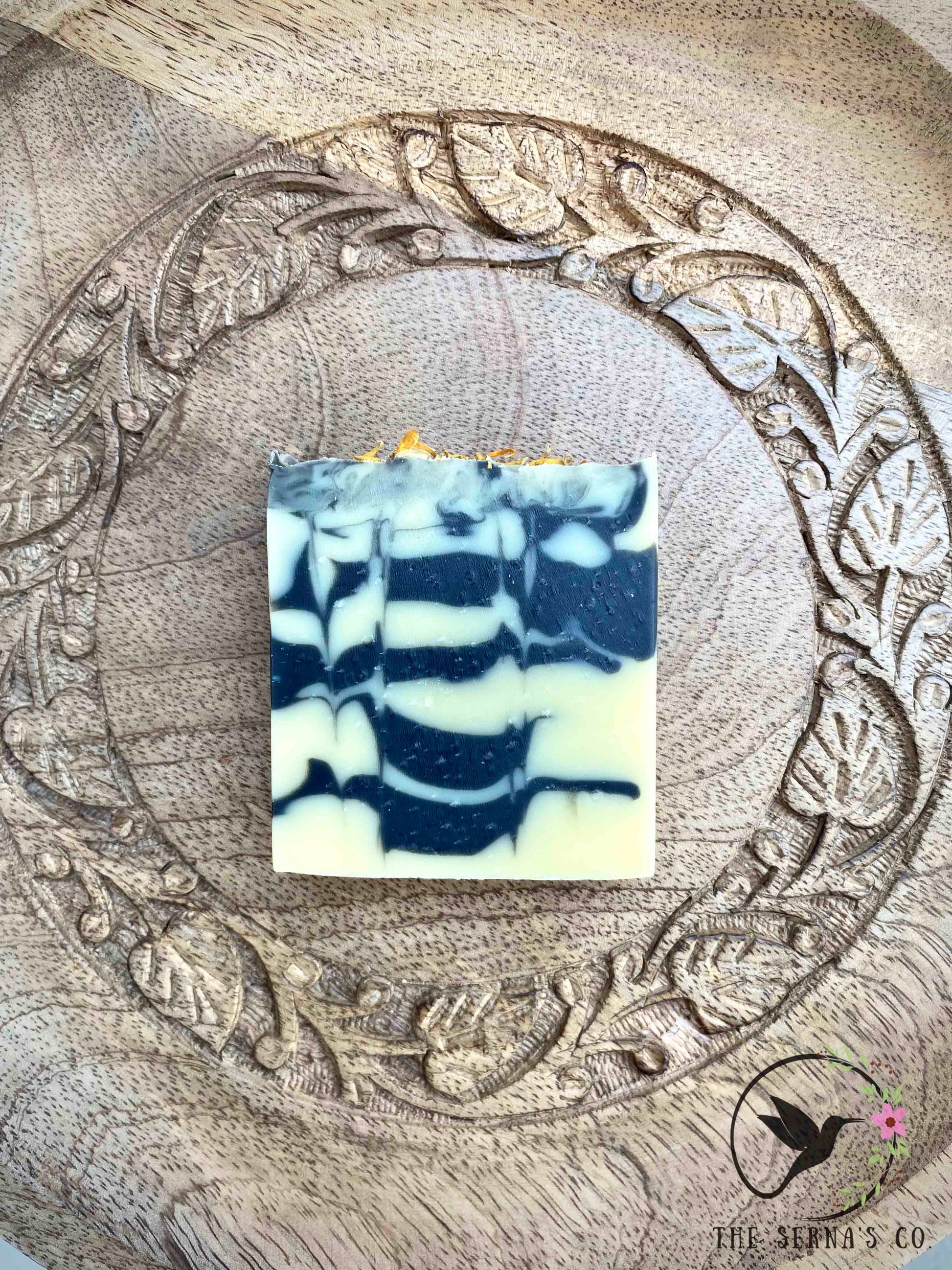 Soap bars displayed on wood with ingredients 