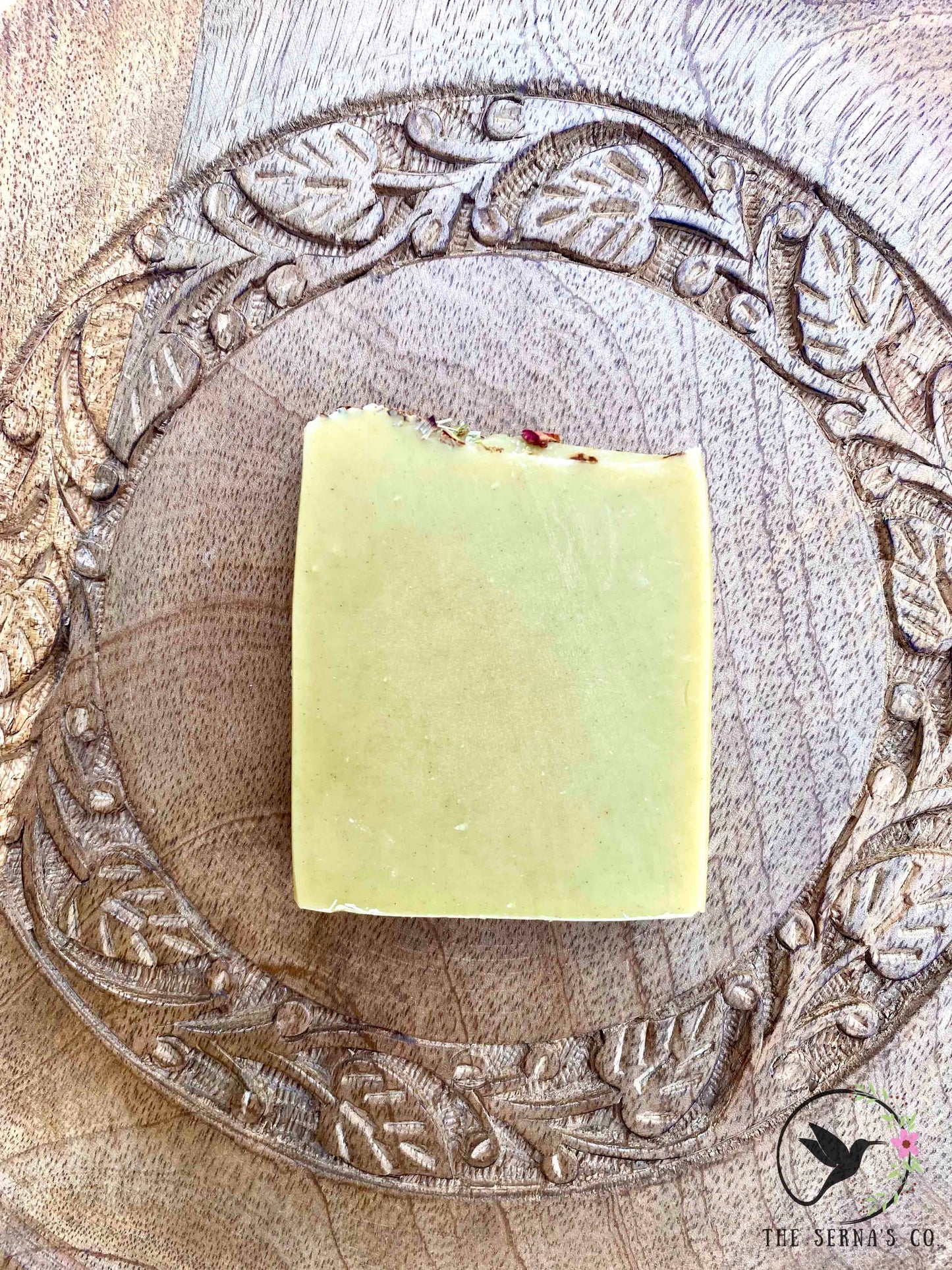 Soap bars displayed on wood with ingredients 