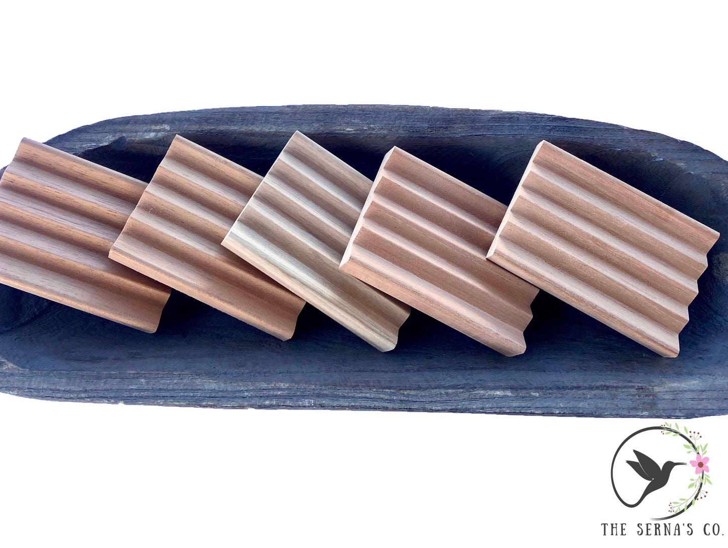 Wooden soap dishes displayed in wooden bowl